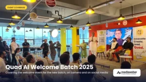 Quad AI Welcome Batch 2025 event with a speaker addressing new students and parents on stage, with mentors seated beside him